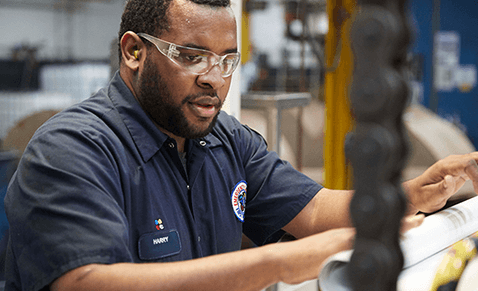 Man in factory wearing safety goggles