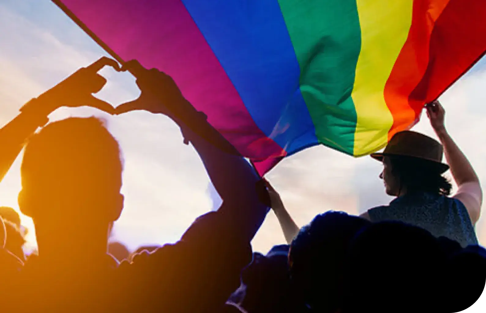 People waving a rainbow flag