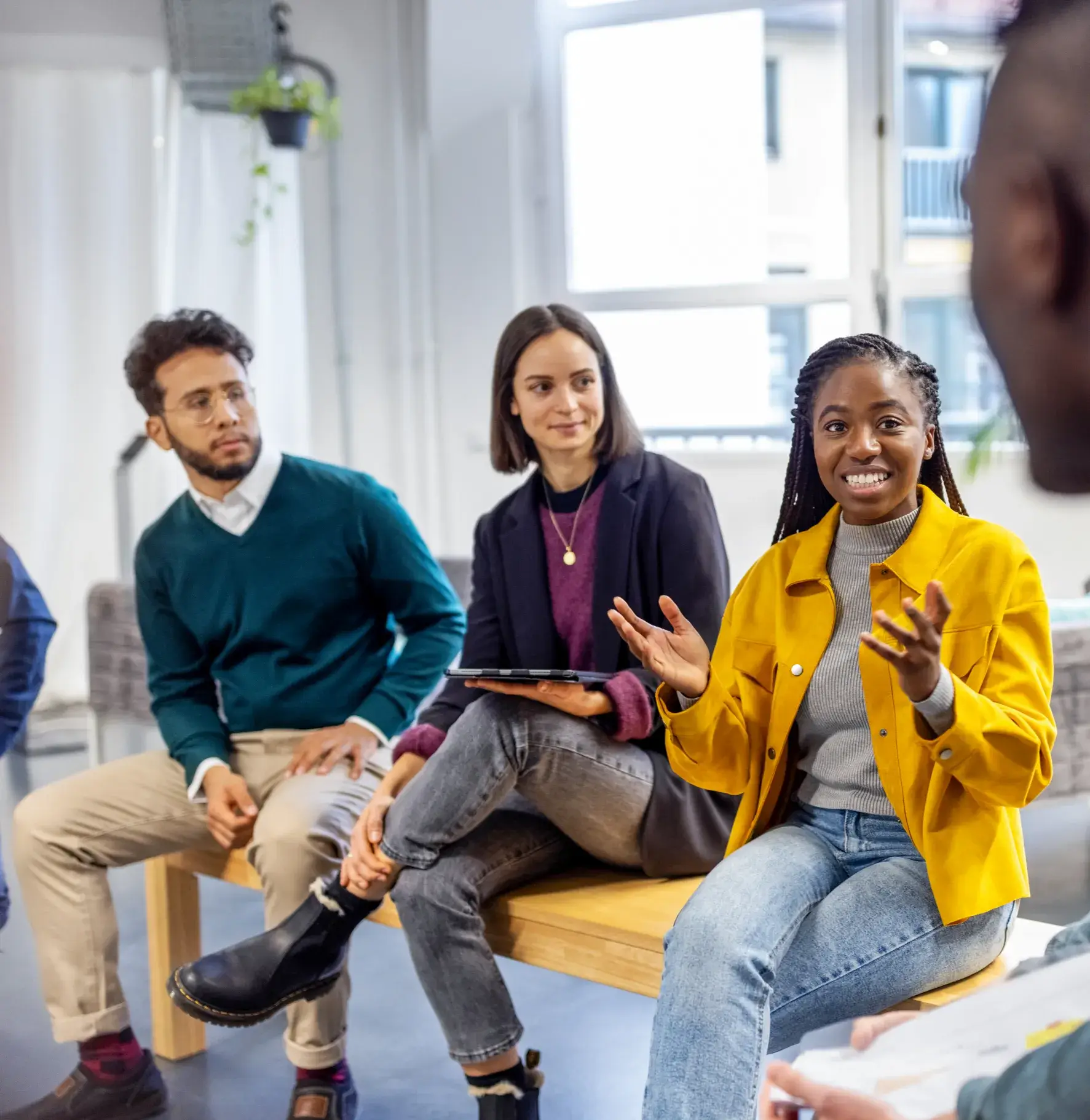 Group of coworkers seated, in conversation