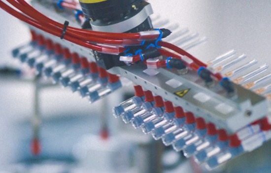 medicines being moved by a robotic arm