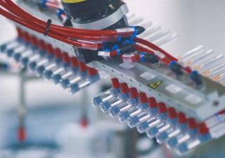 medicines being moved by a robotic arm