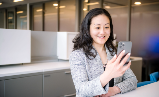 Female presenting employee on a video call in an office setting
