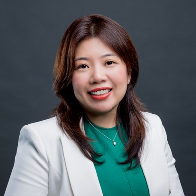 female wearing green shirt smiling for headshot