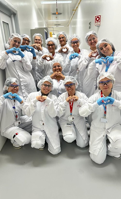 Team of people in lab gear posing for a picture