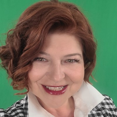 female smiling with green background