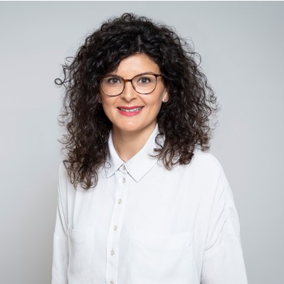 female in white shirt wearing glasses