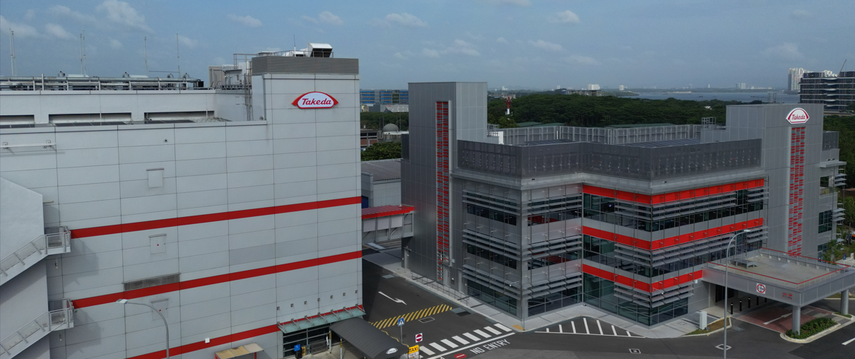 Building with red stripes and the Takeda logo