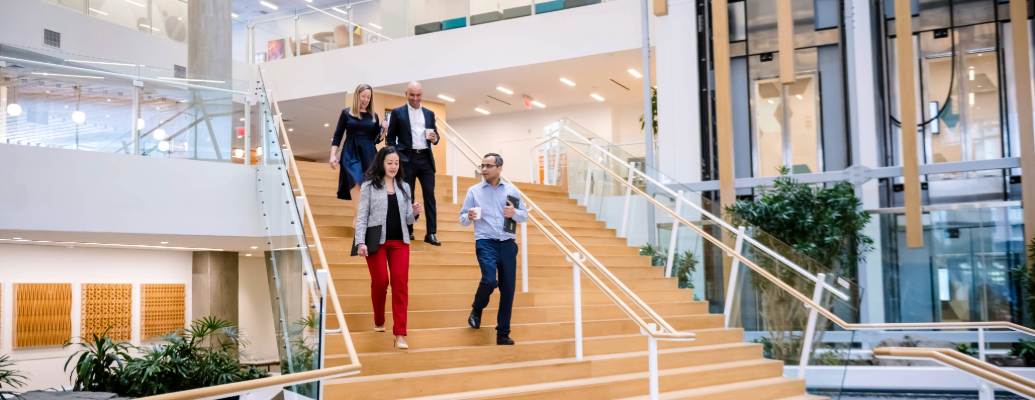 Watch video: people walking down staircase in office