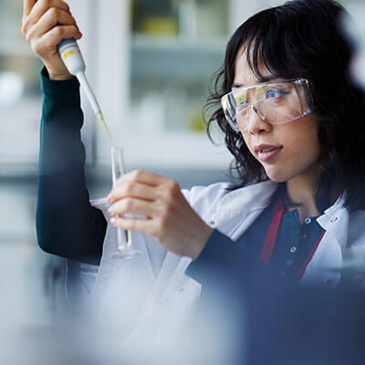 Scientist using pipette and test tube