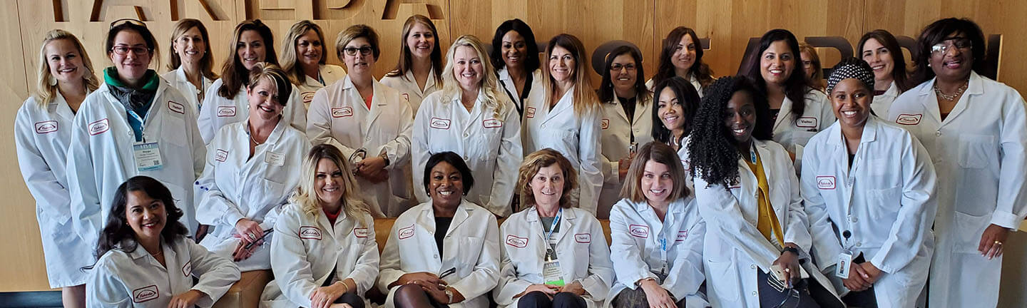 Large group of women in Takeda lab coats