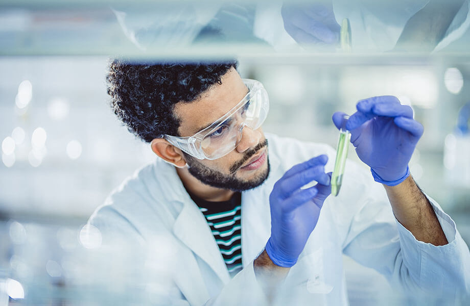 Lab worker examines test tube