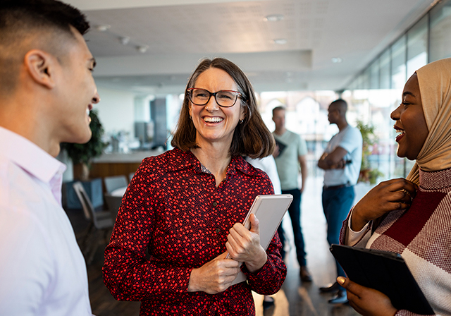 diverse group of office workers smiling and conversing