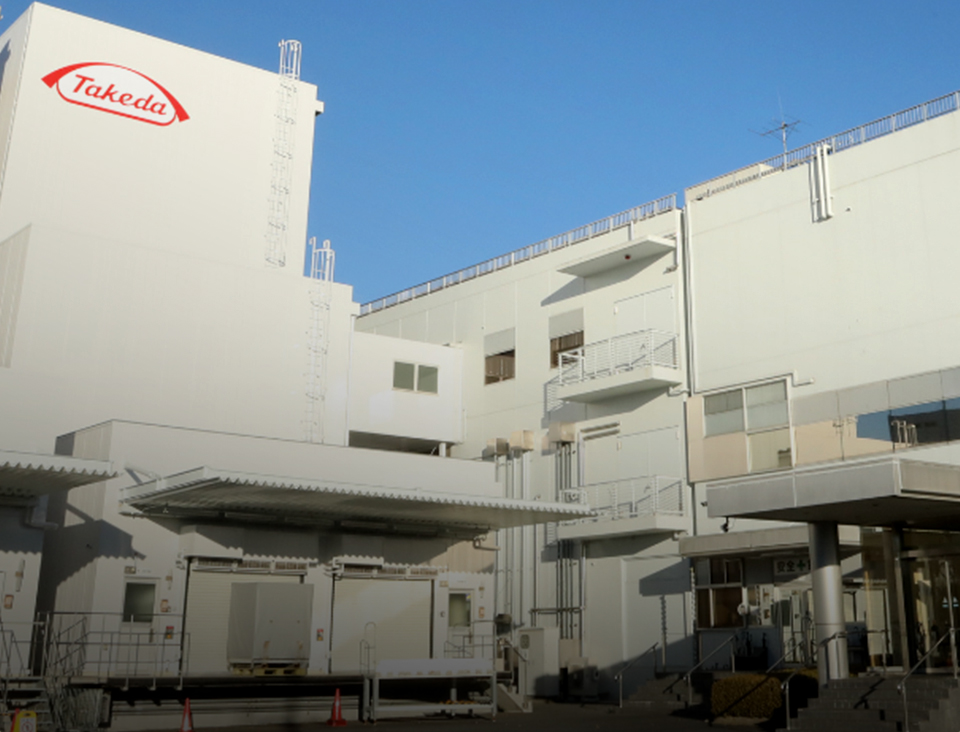 Exterior view of a white Takeda Factory building