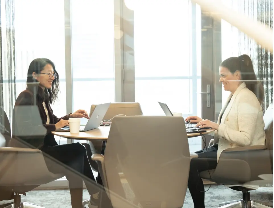 2 women working on laptop