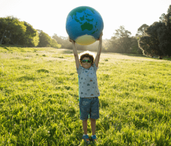 Child holding up a globe of the earth