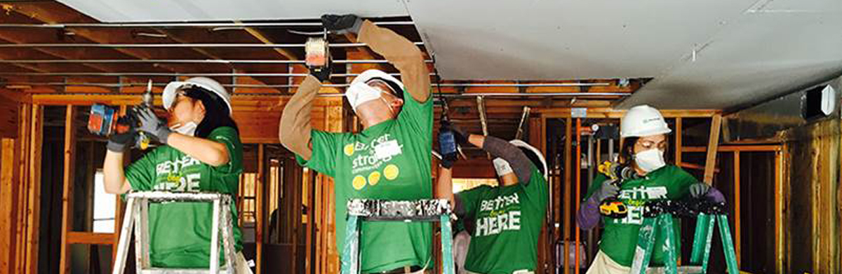 Two TD Ameritrade volunteers doing interior home construction work for charity 
