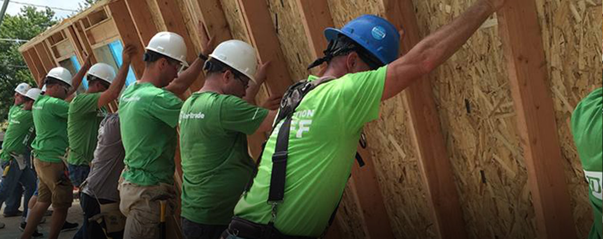 A group of TD Ameritrade volunteers putting up a house frame together