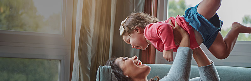 A mother playing with her toddler child