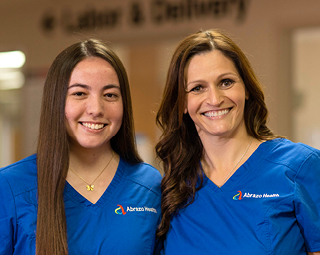 two female nurses in blue scrubs