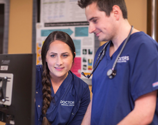 two women and a man having a conversation