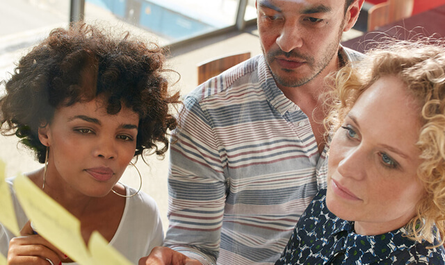 People looking at sticky notes