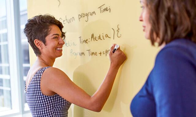 Woman writing on board