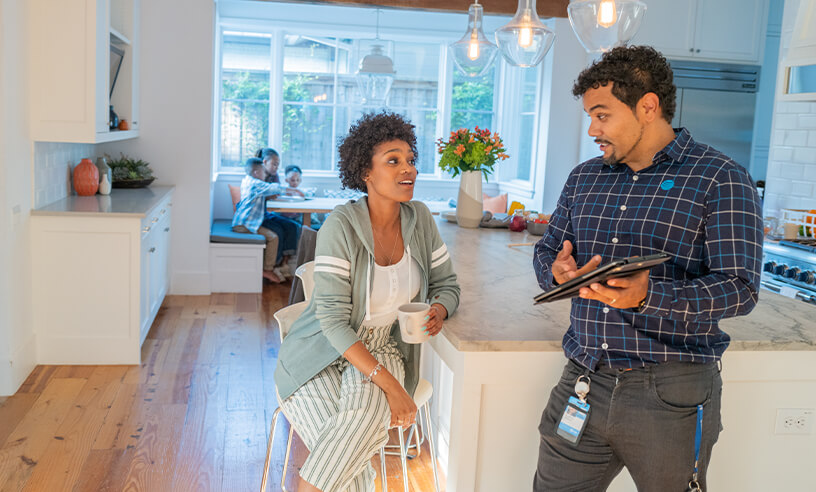Two people talking in a kitchen area