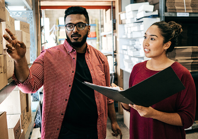 two people reviewing the stock room