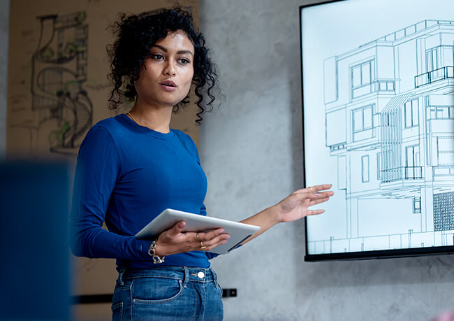 woman presenting at a whiteboard