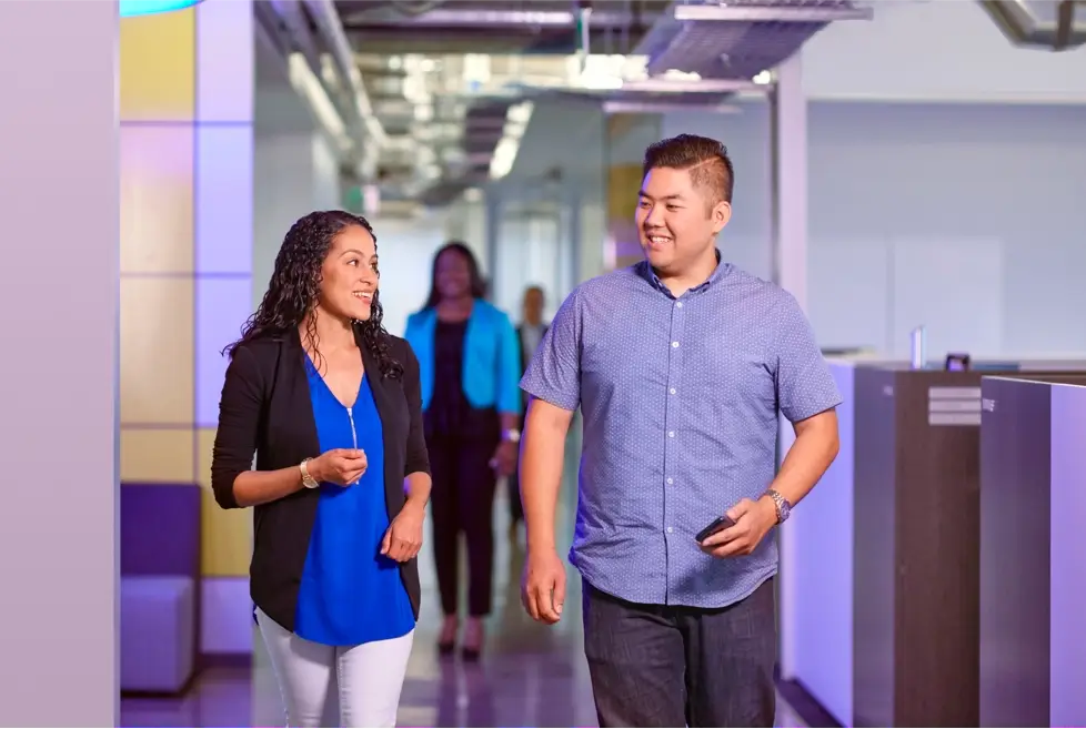 Man and woman walking through the office