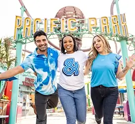 Three people standing in front of Pacific Park