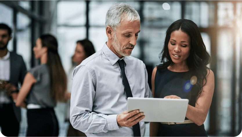 Man and woman looking at papers and talking