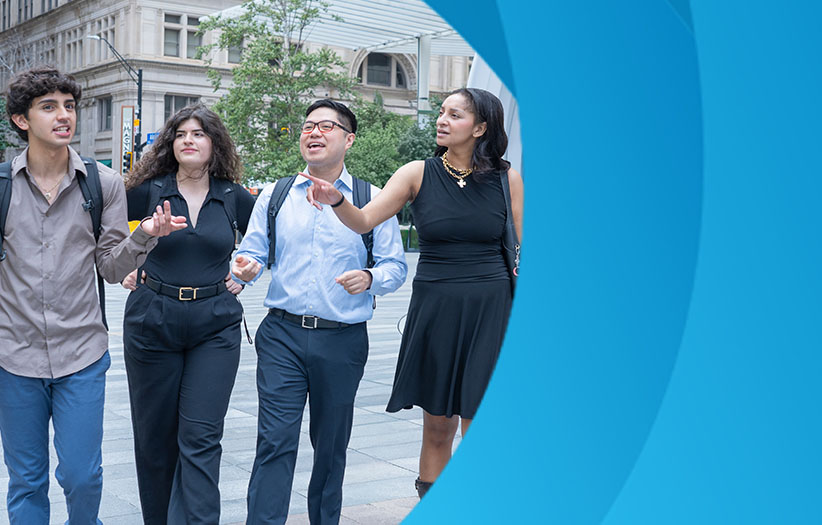 four employees in business clothing walking down the street