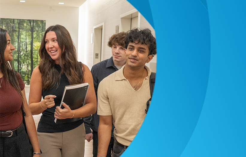 four students walking down the hallway