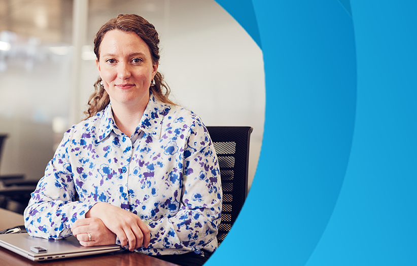 woman sitting a table with closed laptop