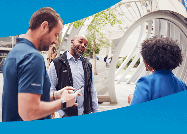 Three employees talking to one another