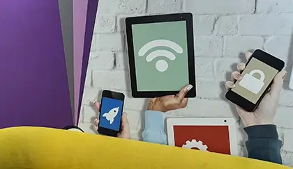 A group of hands holding several mobile devices.