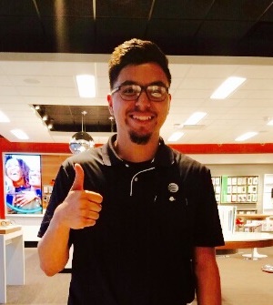 Jacob standing in the middle of an AT&T store giving a big thumbs up.