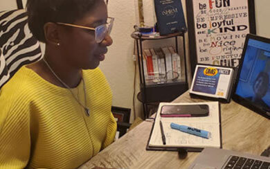 Female employee sitting at desk working on computer