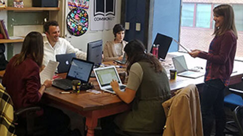 Employees sitting together at a table collaborating