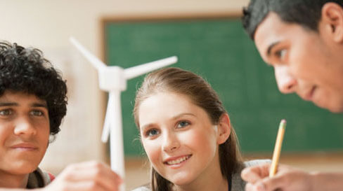 Students studying a model wind turbine