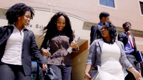 Female students chatting as they leave school