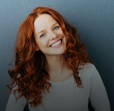 Female employee smiling with her head tilted