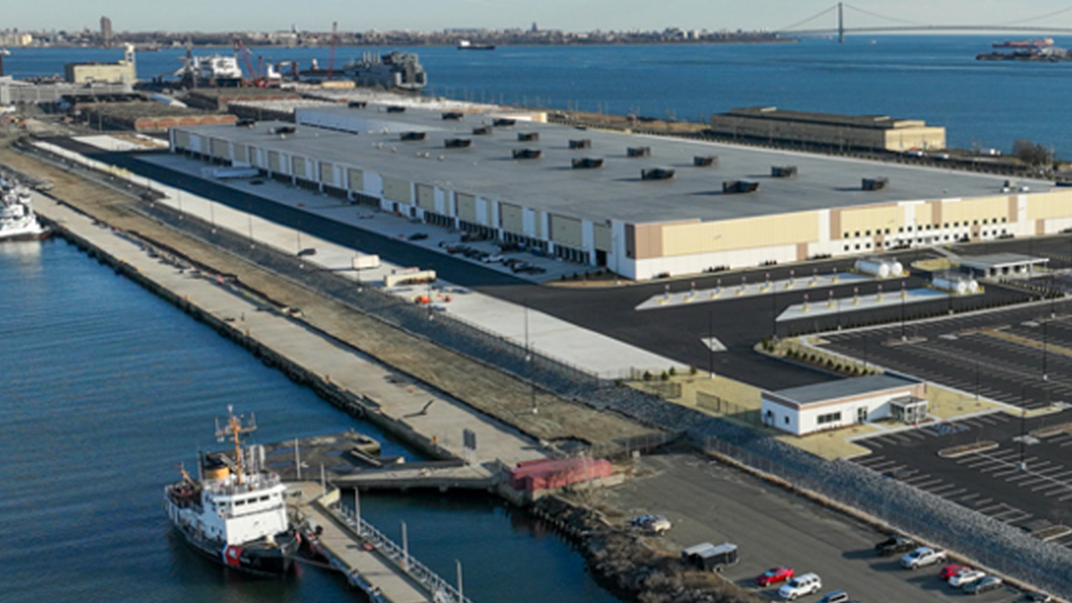 A large warehouse and  shipping dock on the water