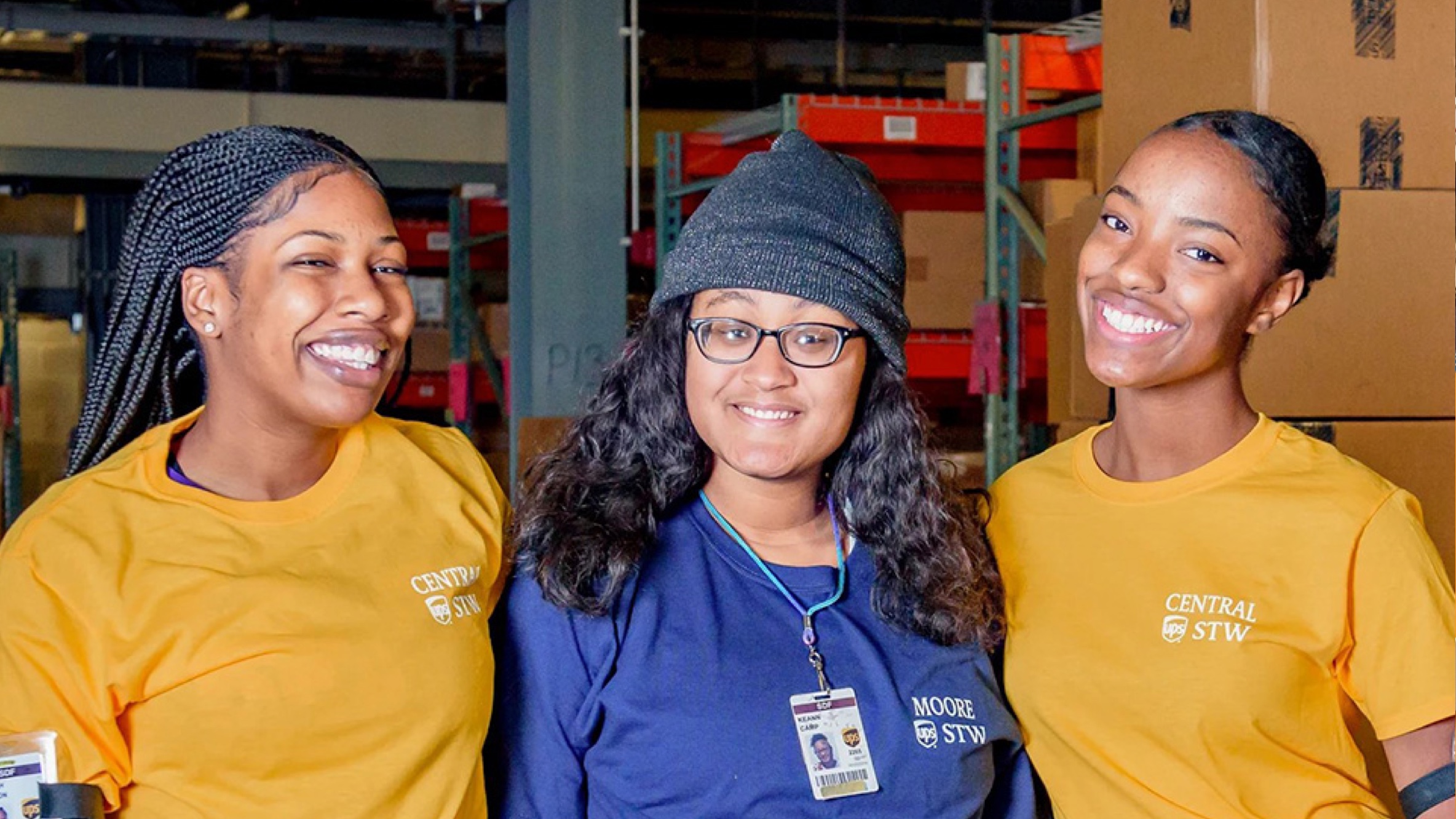 Group of 3 women standing arm to arm smiling