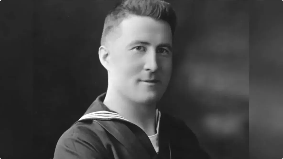 Old picture from 1919 of young man smiling.