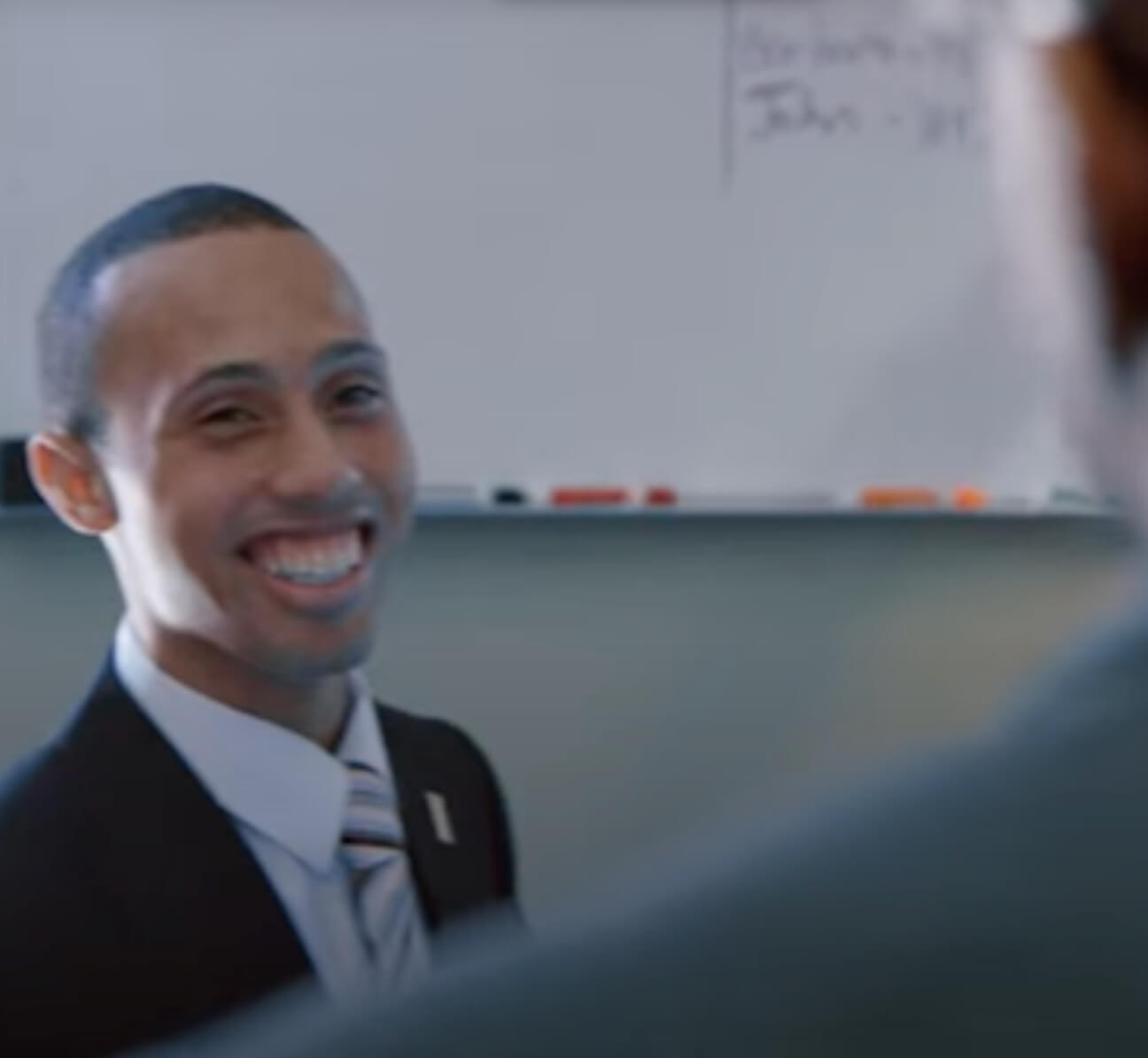 Male employee in suit is smiling