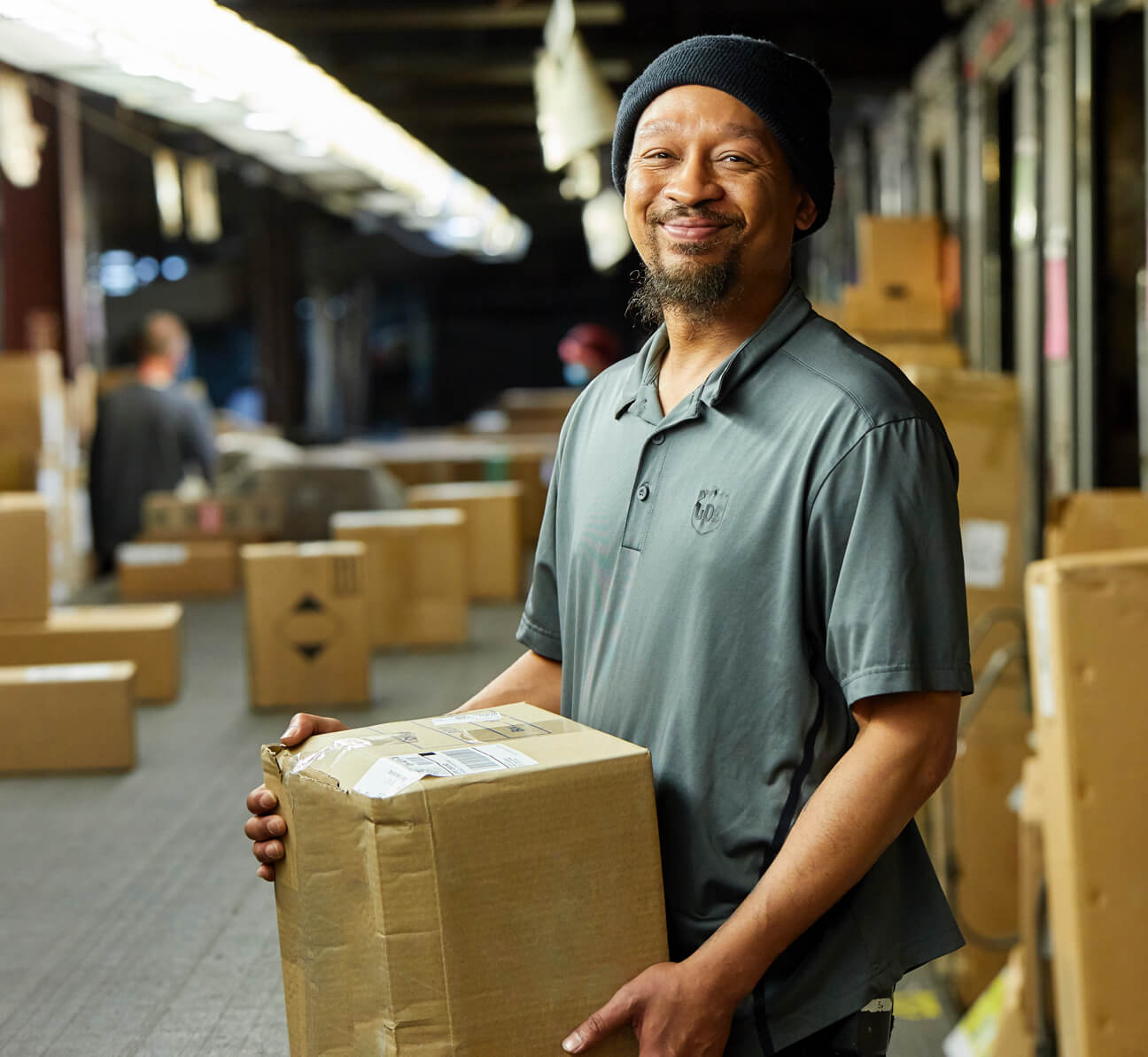 Employee taking package off of belt