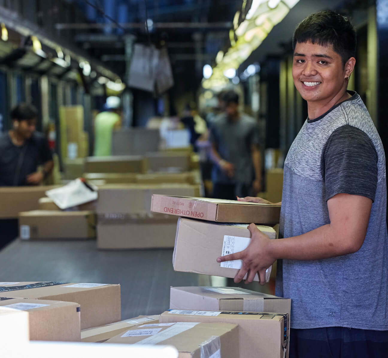 Employee taking packages off of belt