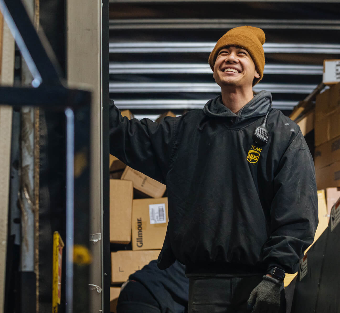 Employee smiling inside back of delivery semi